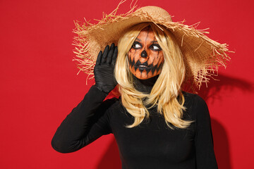Young woman with Halloween makeup mask wears straw hat black scarecrow costume try to hear you...
