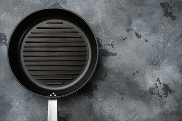 Black iron empty grill pan with copy space for text or food with copy space for text or food, top view flat lay , on gray stone table background