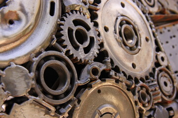 Fototapeta na wymiar Detail of metal gears and wheels and metallic parts welded together, industrial background