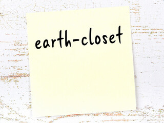 Yellow sheet of paper with word earth-closet. Reminder concept © iushakovsky