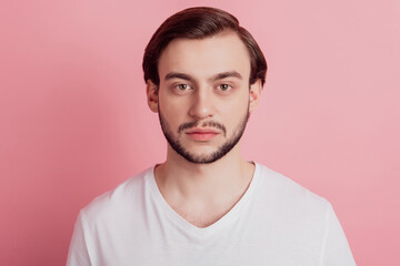 Obraz premium Portrait of calm focused handsome guy look camera on pink background