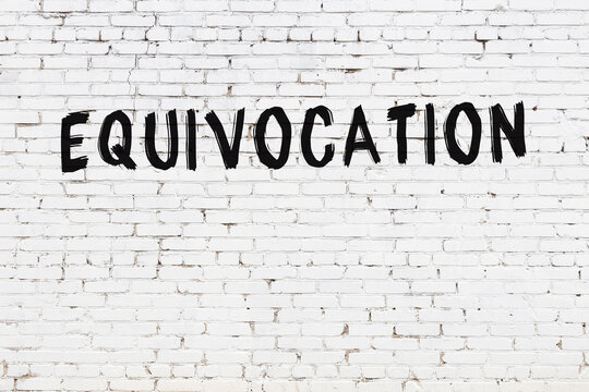 White wall with black paint inscription equivocation on it