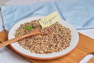 Portion of tricolor grains of fresh quinoa. Vegan food concept.