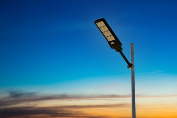 A modern street LED lighting pole. Urban electro-energy technologies. Poles on the road with LED...