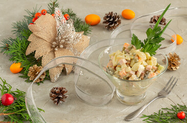 Traditional Russian New Year salad Olivier, serving New Year or Christmas salad on a concrete background