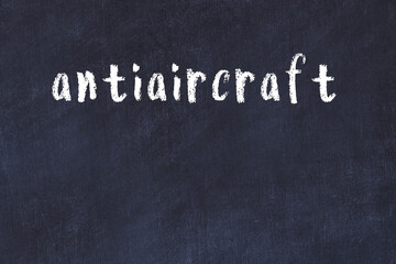 College chalk desk with the word antiaircraft written on in