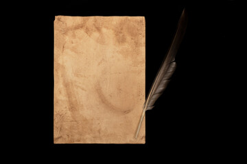 A sheet of paper and a feather.