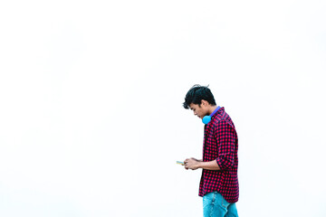 Asian young man using mobile phone outdoor - Asian social influencer having fun with new trends smartphone apps - Generation z, media, technology and youth millennial people lifestyle - obrazy, fototapety, plakaty