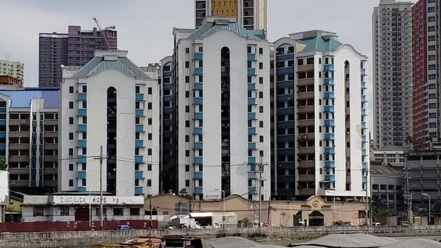 Exterior high rise apartment or condos  day with boats in front by the bay  4k