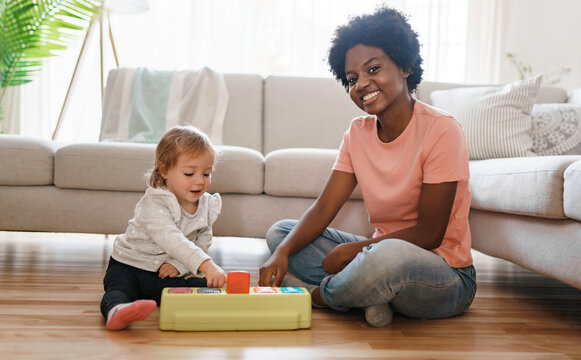 Nursery Babysitter With Baby Play With Toys