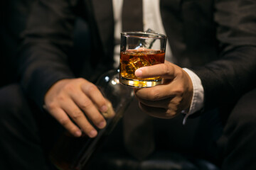 Businessmen in suits drinking whiskey