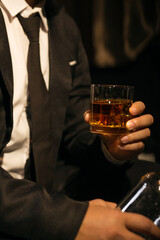 Businessmen in suits drinking whiskey