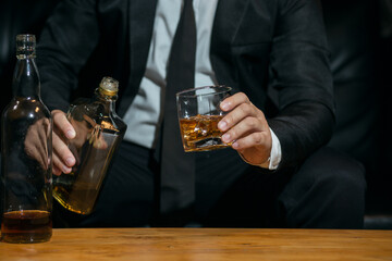 Businessmen in suits drinking whiskey