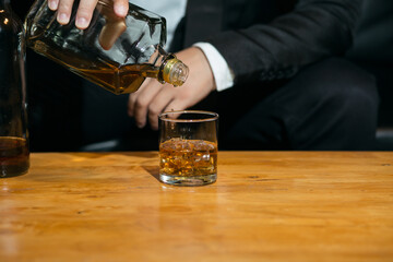 Businessmen in suits drinking whiskey