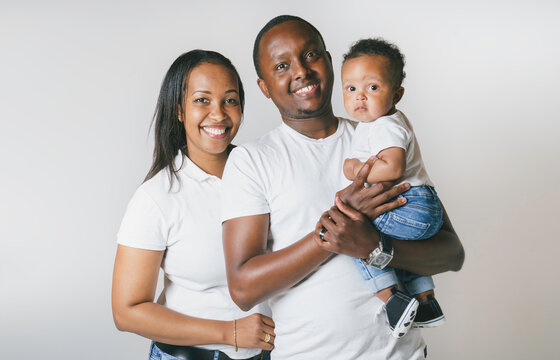 Young African American family in the studio with baby toddler son