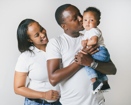 Young African American family in the studio with baby toddler son