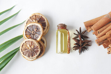 essential citrus oil, dried lemon and spice on table ,
