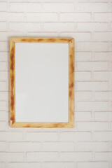 Black frame mockup on table against white wall,