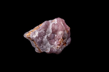 Macro pink Smithsonite mineral stone on microcline on black background
