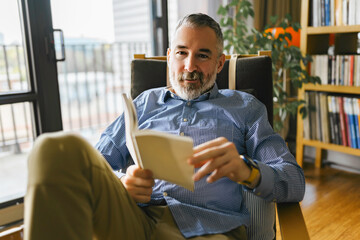 mature Man Reading a Book seat look like relax