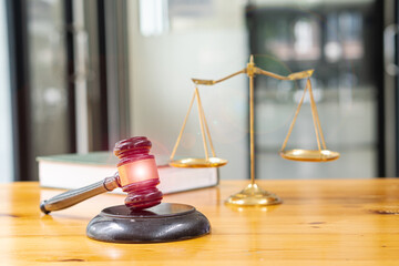 Judge's hammer and brass scales on the table in the law office, legal services, advice, justice and legal concept images.