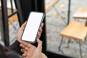 Female hand holding smartphone with blank white screen and space for text Use a mobile shopping app. Check social media news, send mobile SMS messages, order food, deliver food sitting on the couch at