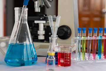 red blue glass flask and chemical structure in research white background in medical science room Research and Innovation - Beaker with Laboratory Formula