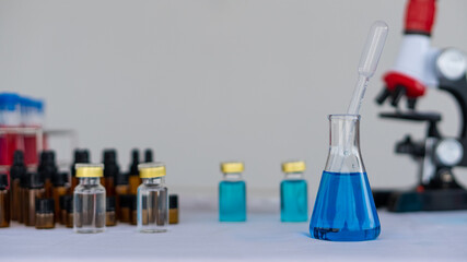 red blue glass flask and chemical structure in research white background in medical science room Research and Innovation - Beaker with Laboratory Formula