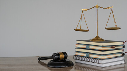 Judge's hammer and brass scales on the table in the law office, legal services, advice, justice and...
