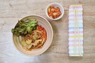 fried yakisoba Japanese noodles slice pork and cabbage with carrot on bowl eat couple pickled vegetable in cup