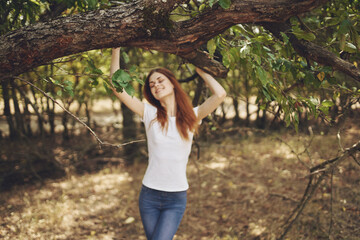 pretty woman outdoors by the tree nature Lifestyle summer