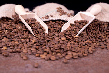 Coffee beans in a sack.  A bag full of coffee.  Coffee beans in the wooden spoon.