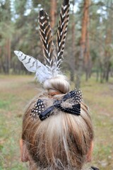 Hair style and feather barrette.