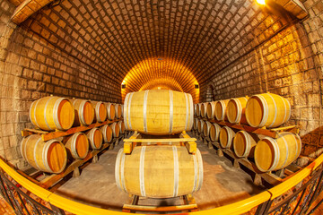  Wine Cellar with Wooden Barrels, Wine barrels stacked in the cellar of the winery