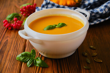 Homemade pumpkin soup with cream and basil