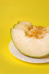 Slices of juicy ripe melon on a plate close-up