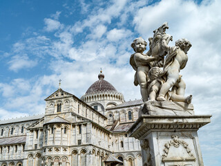 Fototapeta na wymiar Monument with cherubs in front of the cathedral of Pisa in Italy 