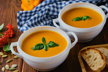 Homemade pumpkin soup with cream and basil