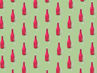 Christmas pattern made with pink champagne bottle and glass on bright light green background. Minimal Christmas party concept. Christmas isometric pattern, background, banner.