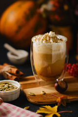Pumpkin latte in a glasses. Autumn drink for Halloween or Thanksgiving.