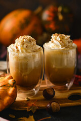 Pumpkin latte in a glasses. Autumn drink for Halloween or Thanksgiving.