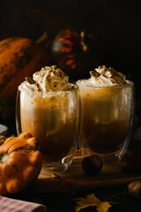 Pumpkin latte in a glasses. Autumn drink for Halloween or Thanksgiving.