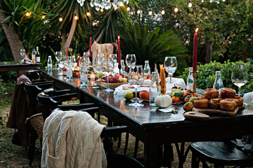 Banquet table setting and arrangement. Holiday table beautifully set with floral decoration. Close...