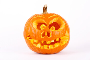 Orange pumpkin carved into creepy and funny Jack o Lantern isolated on white background. All hallows night. Copy space, close up, top view. Halloween party decoration. Trick or treat concept.