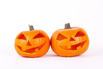 Orange pumpkin carved into creepy and funny Jack o Lantern isolated on white background. All hallows night. Copy space, close up, top view. Halloween party decoration. Trick or treat concept.