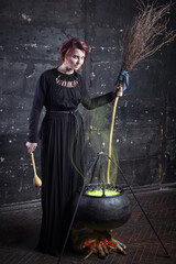 Young beautiful witch preparing a potion for Halloween 