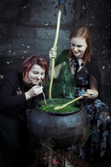 Young beautiful witches preparing a potion for Halloween 