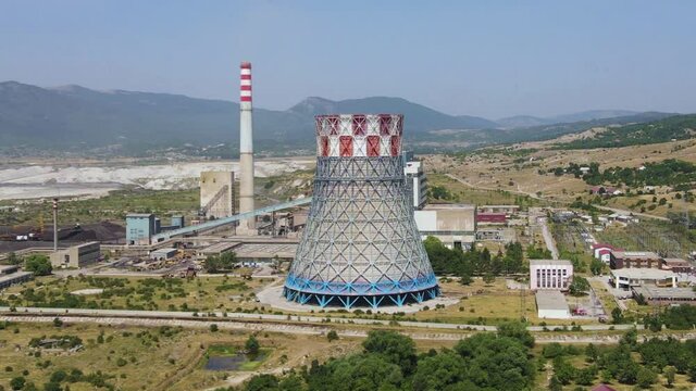 Thermal Coal Power Plant, Gacko, Bosnia and Herzegovina. Aerial View of Cooling Tower and Chimney on Sunny Day, Drone Shot