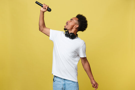 Young Handsome African American Boy Singing Opera Emotional With Microphone.