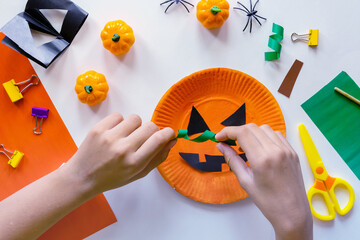 Cuts of paper for Halloween. Hand cut paper. Pumpkins. Scissors and glue. On a light background....